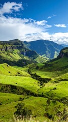 Obraz premium Lush green valley nestled between mountains under a bright sky