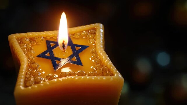 Two lit Hanukkah candles on a golden holder, each with a Hebrew letter inscribed. Symbolizing the holiday's eight days of light and spirituality.