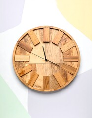 Wooden wall clock on colorful background