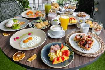 variety of breakfast items, breads, eggs, waffles, cereals, and cheeses