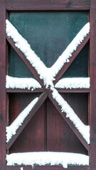Wooden window frame in snow