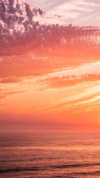 Vibrant sunset over the ocean with dramatic clouds