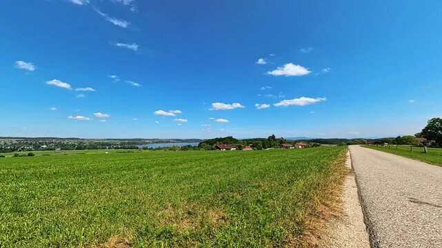 4K Timelapse video with moving clouds near a church at Lake Waging, Traunstein, Rupertiwinkel, Bavaria, Germany