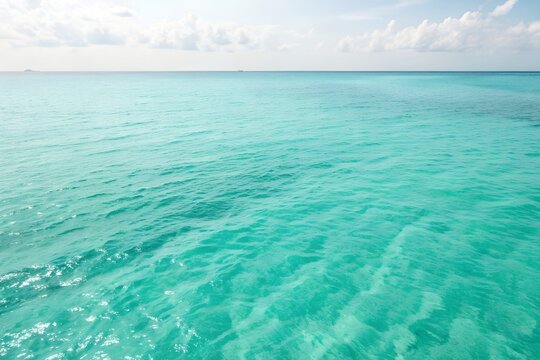 Clear turquoise ocean water with sunlight reflections