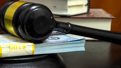 There is a wad of money on the table next to the judge's gavel.