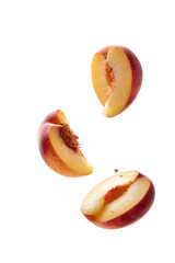 Three peach slices, suspended in mid-air, against a black background.  A close-up view reveals the juicy flesh and vibrant red-pink skin of the fruit.  Each segment is sliced neatly.