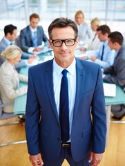Confident businessman leads meeting with team in modern office