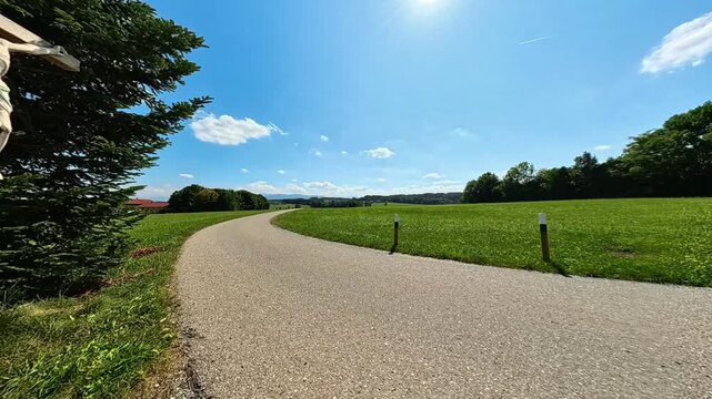 4K Timelapse alpine video with moving clouds and a wayside cross near Lake Waging, Traunstein, Rupertiwinkel, Bavaria, Germany