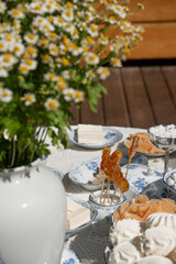 Traditional Russian sweets served on fine porcelain dishes: marshmallows, marmalade, candies, and handmade lollipops in the shape of cockerels
