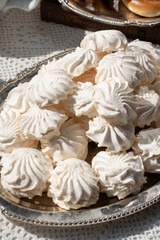 Close-up of classic white Russian zefir on a vintage silver tray in natural daylight