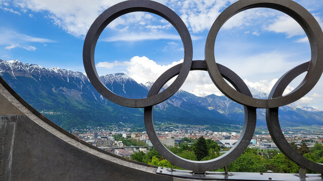 View of Innsbruck through the Olympic rings from the Olympic Park at Bergisel Hill. In the background - Alps. May 19, 2023. Innsbruck, Austria.