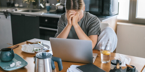  Gen Z woman working from home at cozy kitchen table with laptop and phone. Digital nomad lifestyle, mindfulness, remote work, balance, mental calm and modern freelancing
