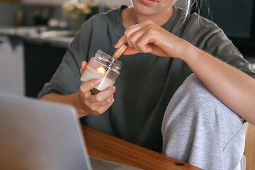  Gen Z woman working from home at cozy kitchen table with laptop and phone. Digital nomad lifestyle, mindfulness, remote work, balance, mental calm and modern freelancing