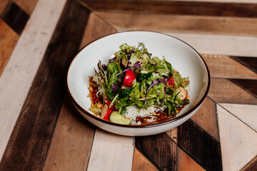 Fresh green salad with lettuce leaves. Healthy vegetarian meal close up.