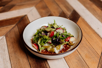 Fresh green salad with lettuce leaves. Healthy vegetarian meal close up.