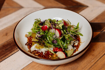 Fresh green salad with lettuce leaves. Healthy vegetarian meal close up.