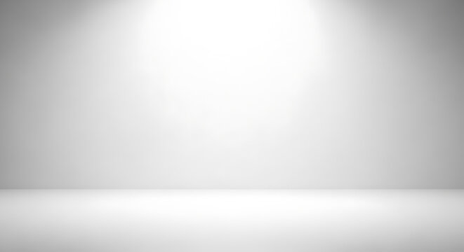 Clean empty white studio room with spotlight creating smooth gradient background, perfect for product photography, presentations, or advertising display.