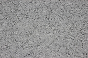 Textured gray wall surface with intricate patterns and subtle variations, showcasing a modern architectural design element for backgrounds and creative projects