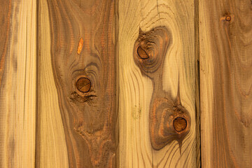 Natural wood texture featuring rich grain patterns, knots, and warm tones, creating an inviting and...