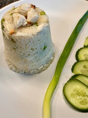 Thai Crab Fried Rice with scallion and cucumber, wok-fried jasmine rice with crab meat close-up