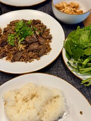 Northern Thai Pork Larb Kua with sticky rice, pork cracklings and fresh herbs, traditional spicy stir-fry minced pork home-cooking set 