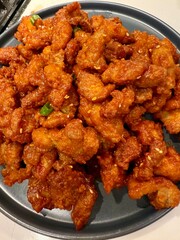 Korean Gochujang Fried Chicken, crispy spicy glazed chicken pieces on plate, Asian comfort food home-cooking close-up