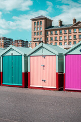 Colorful beach huts line the coast in Brighton, showcasing the vibrant seaside culture and...