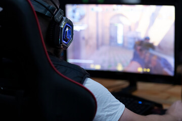 Successful Gamer Playing and Winning in Video Game at game room