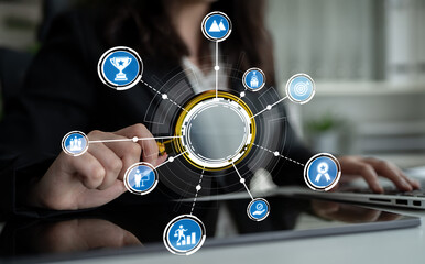 A business professional engages with technology icons that symbolize diverse elements of business performance, strategy, and teamwork in a modern office environment. Crux