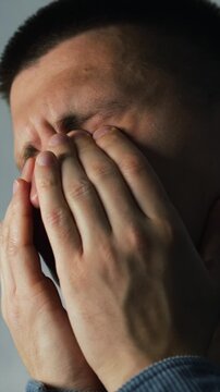 A man squints and rubs his eyes from fatigue.
Tired eyes after working on a computer.
Online work and eye fatigue.
Painful and dry eyeballs.
Tired eyelids in an adult man.