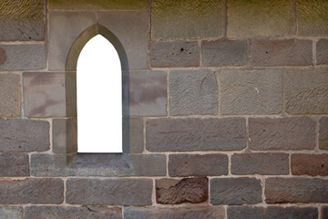 An arched transparent window in a stone church wall.
