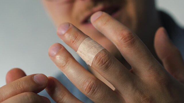 A sore finger wrapped in medical tape.
Pain in the hand and a burn on the hand.
Protection against infection and viruses.
Adhesive antibacterial tape on the finger.