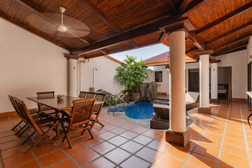 Cozy covered patio with dining area and small pool