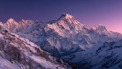 Majestic snow-capped mountain range bathed in the soft hues of sunrise or sunset, showcasing a vast expanse of pristine peaks and valleys