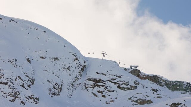 Whistler mountain peak chair lift, ski lift, peak chair, skiers. 4K 24FPS