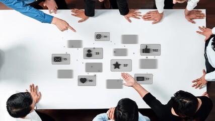 A diverse team collaborates around a table, discussing strategies and data visualizations for social media engagement, focusing on metrics and performance insights. Raster - Powered by Adobe