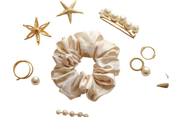 Cream-colored silk hair tie and gold jewelry accents, including starfish and pearls, arranged on a black background
