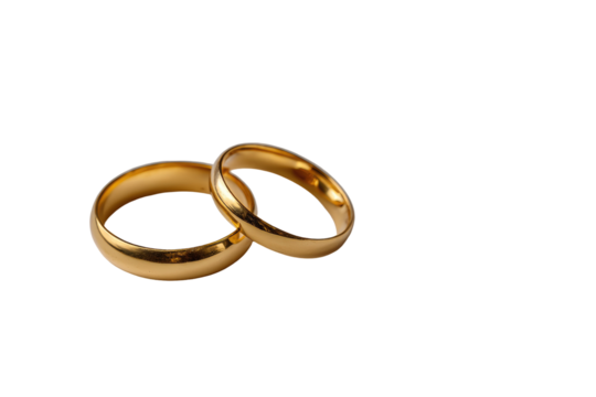 Two gold wedding bands overlap on black background.  Smooth, polished surfaces.  Simple, classic design