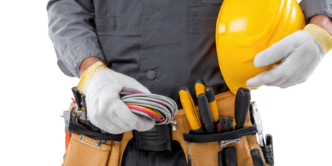 Electrician in work uniform, holding tools and wires