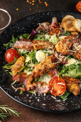 Caesar salad with chicken, bacon and parmesan
