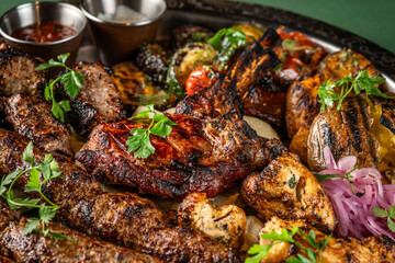 Grilled meat assortment with vegetables and herbs