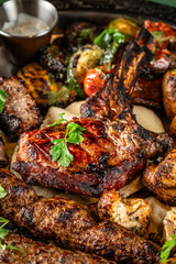 Grilled meat assortment with vegetables and herbs