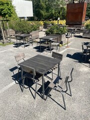 In a designated parking lot area, there is a distinct arrangement, a row of tables and chairs set up for outdoor gatherings