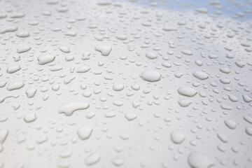 A car with water droplets on its hood