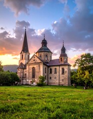 Church at sunset over a grassy field