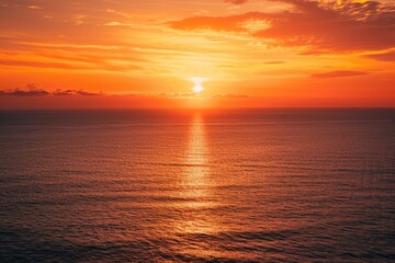 Fototapeta premium Vibrant sunset over the ocean with golden reflections, creating a serene atmosphere