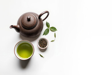Asian tea set - iron teapot and ceramic cups with green tea and leaves. Traditional tea composition on white background, copy space.