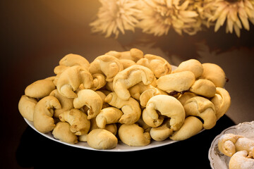 Homemade baked goods. Hand-rolled yeast dough croissants with jam, served on a white platter against a dark background. Warm, sweet autumn desserts. Delicious yeast dough with filling.