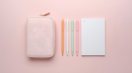 Minimal flat lay of pastel stationery set with pencil case, colorful pens, and blank notebook on soft pink background, creative workspace and school supply concept