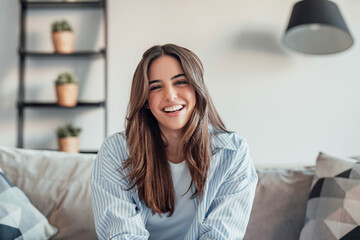 Happy cheerful student talking to the camera, connecting in conference video call with coworkers or friends. Having fun telling distance family her new experiences